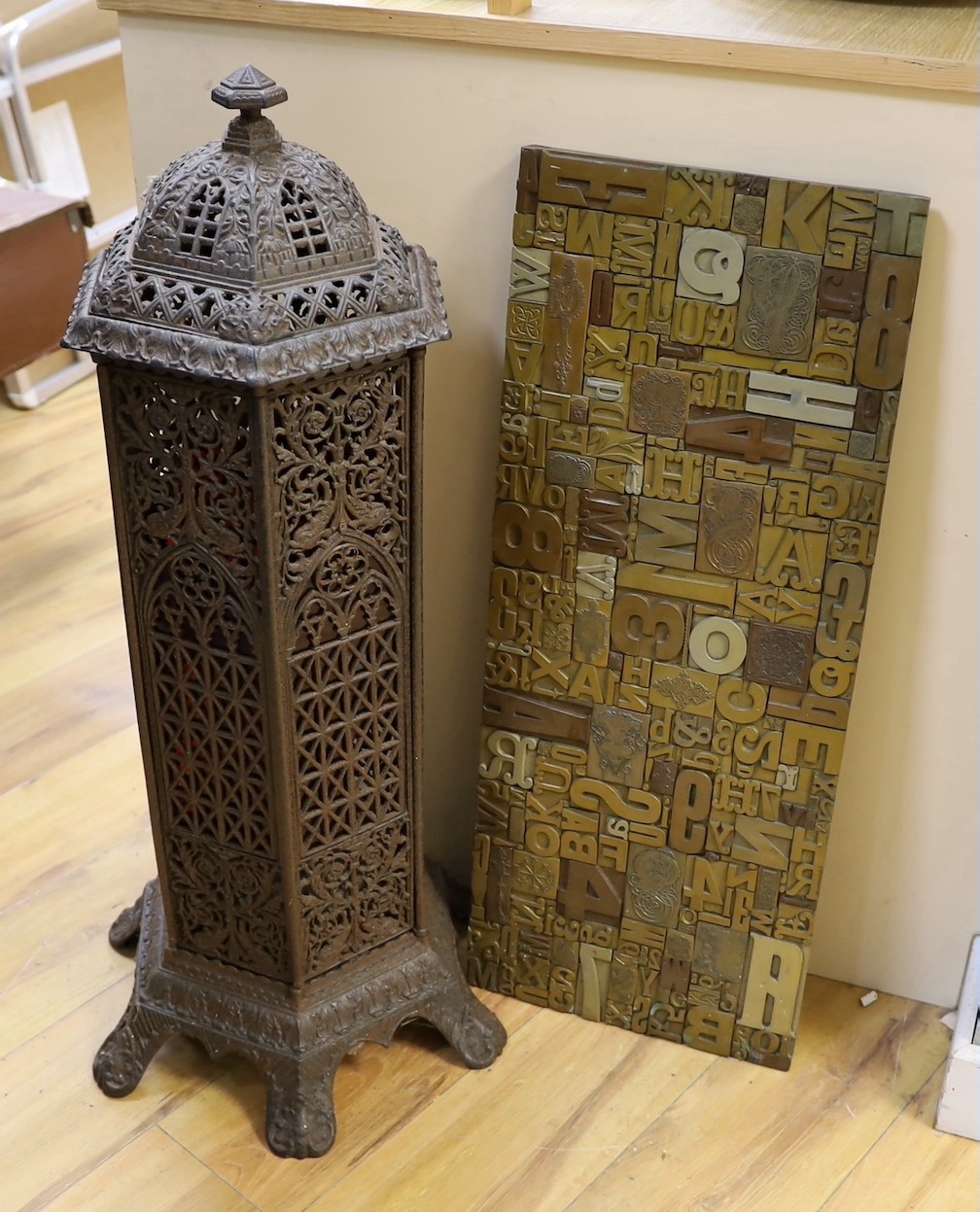 A Victorian cast iron conservatory heater and a printing block display